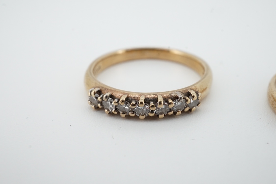 A 9ct gold and solitaire diamond set ring, size O/P and a 9ct gold an seven stone diamond set half hoop ring, size O, gross weight 4 grams.